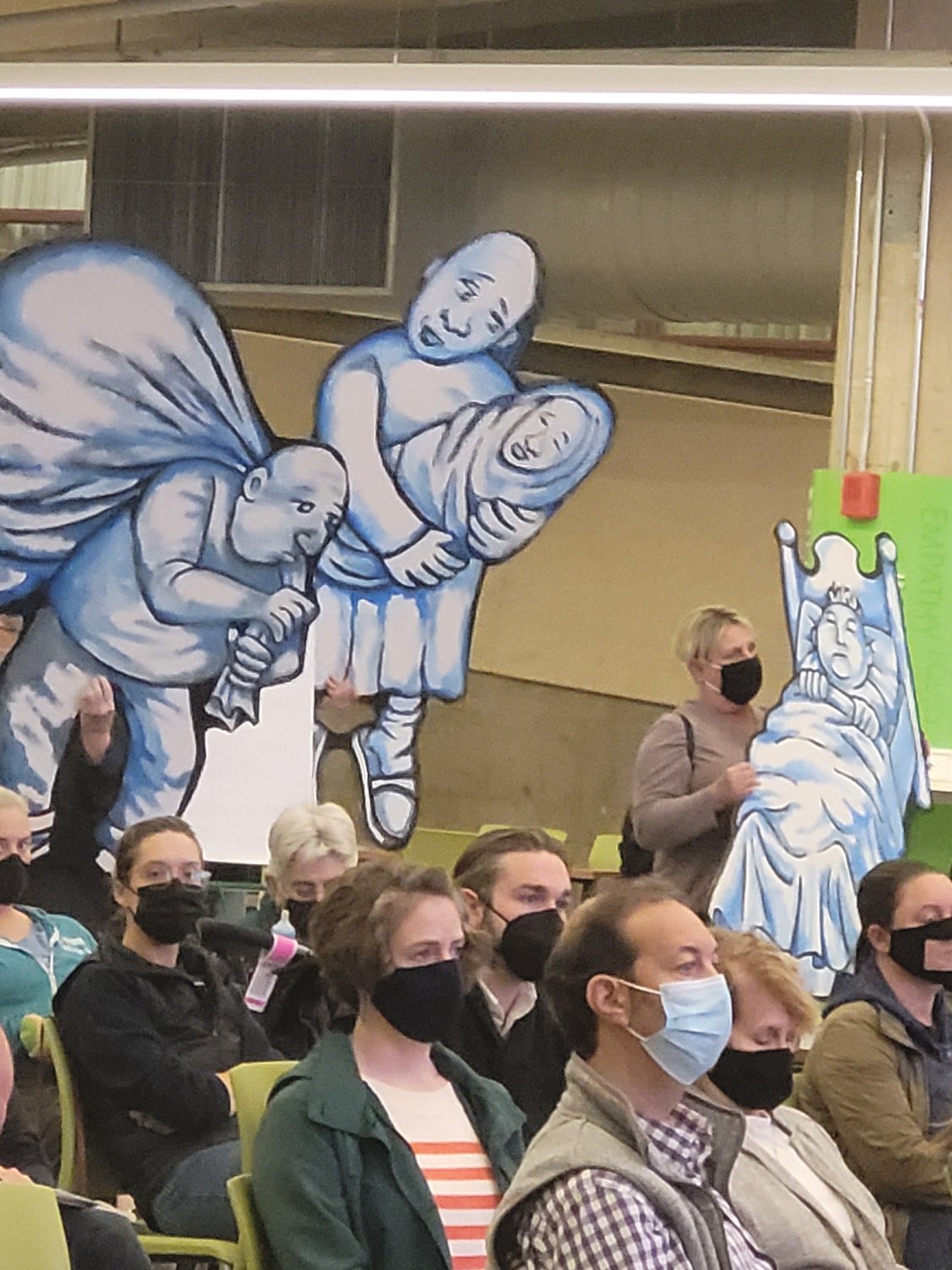 GIMME SHELTER: Members of the Rhode Island Homeless Advocacy Project carried life-size cutouts representing “unsheltered” Ocean State residents, during a RI 2030 public forum Tuesday night. 